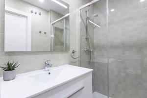 a bathroom with a sink and a glass shower at Malaga Center Flat Cathedral in Málaga