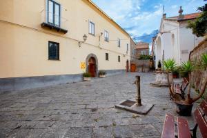 a courtyard with benches and a building at Unconventional Sorrento Coast in Sant'Agnello