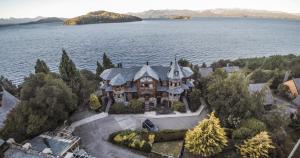 an aerial view of a house on the water at Lirolay apartments in San Carlos de Bariloche