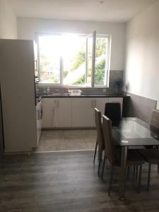 una cucina e una sala da pranzo con tavolo e finestra di Dreamland Apartments EU, Brussels a Bruxelles