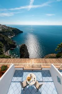 a view of the ocean from the balcony of a house at Grand Hotel Tritone in Praiano