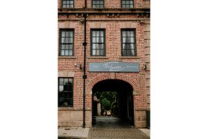 an entrance to a brick building with a sign on it at OYO The Leven in Stokesley