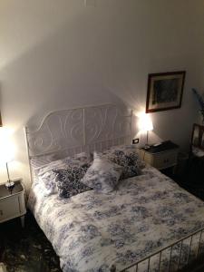 a bedroom with a bed with pillows and two lamps at Art&Kitchen in Savona