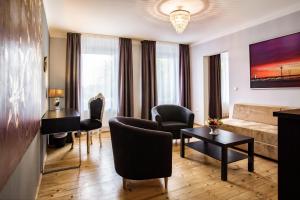a living room with a couch and a table at Hotel Royal Jülich in Jülich