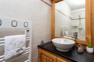 a bathroom with a sink and a mirror at Le Paradis 25 Apartment - Chamonix All Year in Chamonix-Mont-Blanc +13 photos