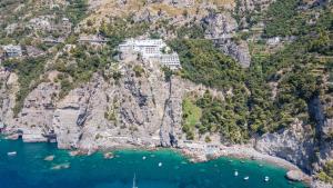 an aerial view of a mountain with a building on it at Grand Hotel Tritone in Praiano