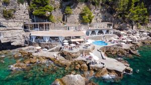 an aerial view of a resort on a rocky cliff at Grand Hotel Tritone in Praiano