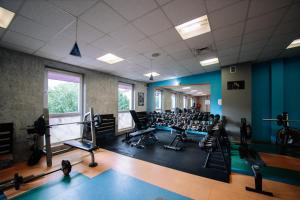 a gym with a lot of treadmills and exercise equipment at Karpackie Pokoje in Krosno