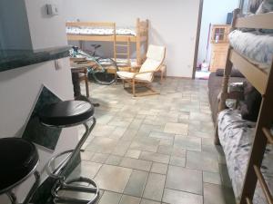 a room with a tile floor and a table and chairs at Apartma Gače in Semič