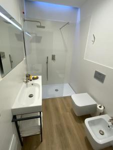 a bathroom with a toilet and a sink and a shower at Residenza Acqva di Mare in Cagliari