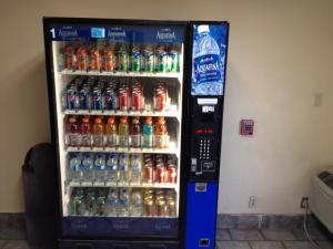 a soda vending machine filled with lots of soda bottles at Motel 6 Elk City, Ok in Elk City
