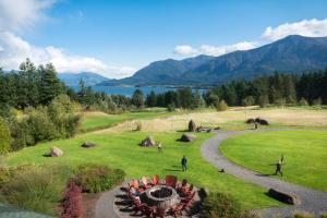 a group of people walking around a field with a fire pit at Skamania Lodge in Stevenson
