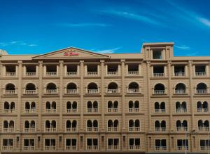 a large building with many windows and a blue sky at Two Bedroom Deluxe Apartment In Bahria Town in Rawalpindi