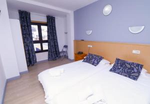 Voodi või voodid majutusasutuse Hotel Merino toas