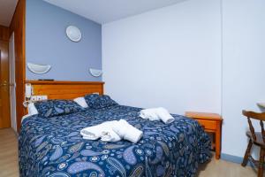Voodi või voodid majutusasutuse Hotel Merino toas