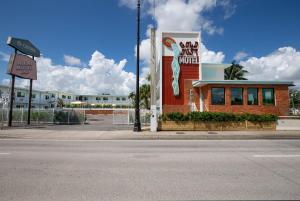 a building with a mermaid painted on the side of it at Selina Gold Dust in Miami