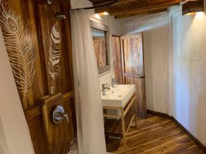 a bathroom with a sink and a mirror at Hotel Tortuga Village in La Herradura