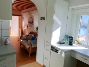 a kitchen and a living room with a couch at Apartment Müllerstiege in Hallstatt +26 photos