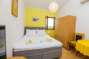 a bedroom with a bed with two hats on it at Apartments Maslina Božava in Božava