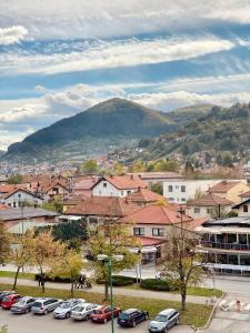 a city with cars parked in a parking lot at City Break Apartment in Visoko