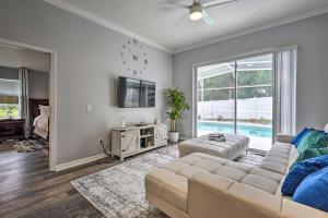 a living room with a couch and a tv at Apopka Single-Story Home with Private Lanai and Pool! in Orlando