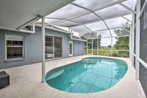 a swimming pool in a house with a glass ceiling at Apopka Single-Story Home with Private Lanai and Pool! in Orlando