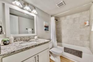 a bathroom with a sink and a toilet and a mirror at The Swank - Close to Downtown in Dallas +18 photos