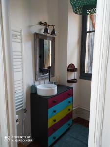 a bathroom with a sink and a colorful dresser at Le Selamat, Logis XL au calme avec Terrasse in Carcassonne