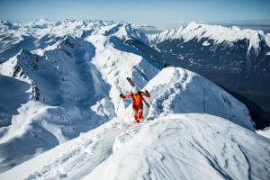 a man standing on top of a snow covered mountain at La Pépite in Luchon