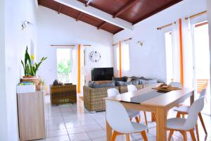 a living room with a table and chairs at Villa Sunrise in Deshaies