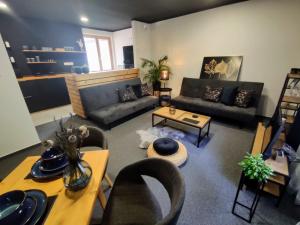 a living room with couches and chairs and a table at Apartman Park Žilina & Free Parking in Žilina