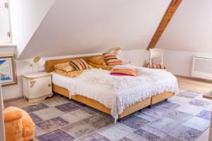 a bedroom with a bed, a chair, and a rug at Dubrovnik Luxury Apartments in Dubrovnik
