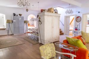 a living room with a large white cabinet and chairs at Dubrovnik Luxury Apartments in Dubrovnik