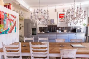 a kitchen with a table, chairs and a refrigerator at Dubrovnik Luxury Apartments in Dubrovnik