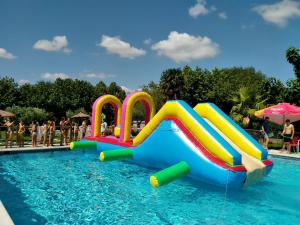 a water slide in a swimming pool at Complejo Turístico Las Cañadas Casas de Campo- Actividades Gratuitas Todos los Fines de Semana in Baños de Montemayor
