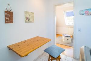 a kitchen with a wooden table on the wall at Falkennest 2 in Westerland (Sylt)