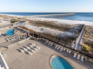 an aerial view of a beach with chairs and a pier at Summerwind in Navarre