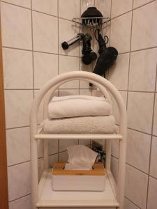 a towel rack with towels on it in a bathroom at Jena Paradies in Jena +1 photo