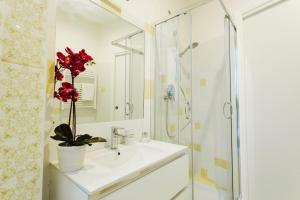 a white bathroom with a sink and a shower at LUXURY SWEET HOME FARNESE - CAMPO DEI FIORI in Rome