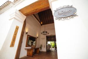 a entrance to a building with a sign on the wall at Bioma Boutique Hotel in Mompos