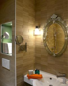 a bathroom with a sink and a mirror at Hôtel St Pierre in Saumur