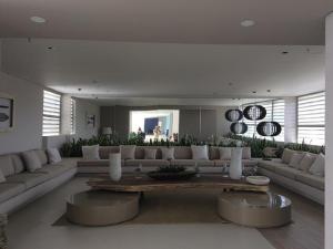 a living room with a large couch and a table at New Apartment Reserva del Mar 1421 Santa Marta ocean view in Santa Marta