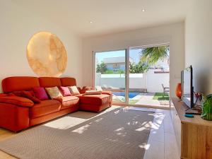 a living room with a red couch and a television at Villa Sol - San Pedro del Pinatar - 1710 in San Pedro del Pinatar