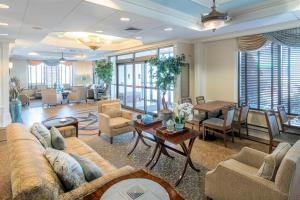 a living room with a couch and a table at Five Towns Inn - JFK Airport in Lawrence