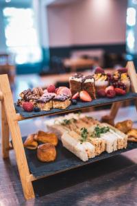 a wooden table topped with a variety of pastries at Portbyhan Hotel in Looe