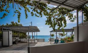 a patio with a view of the beach and the ocean at Summer Vibes in Achlia