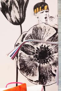 a drawing of a woman holding a flower at Motel L Hammarby Sjöstad in Stockholm