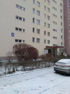 a car parked in a parking lot in front of a building at Os. 2 pułku 26 - studio by Homeprime in Kraków