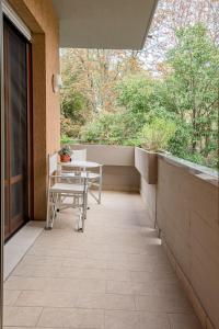 a patio with a table and chairs on a balcony at ForliHouse in Forlì
