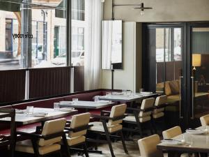 a dining room with tables and chairs and a window at The Robey in Chicago